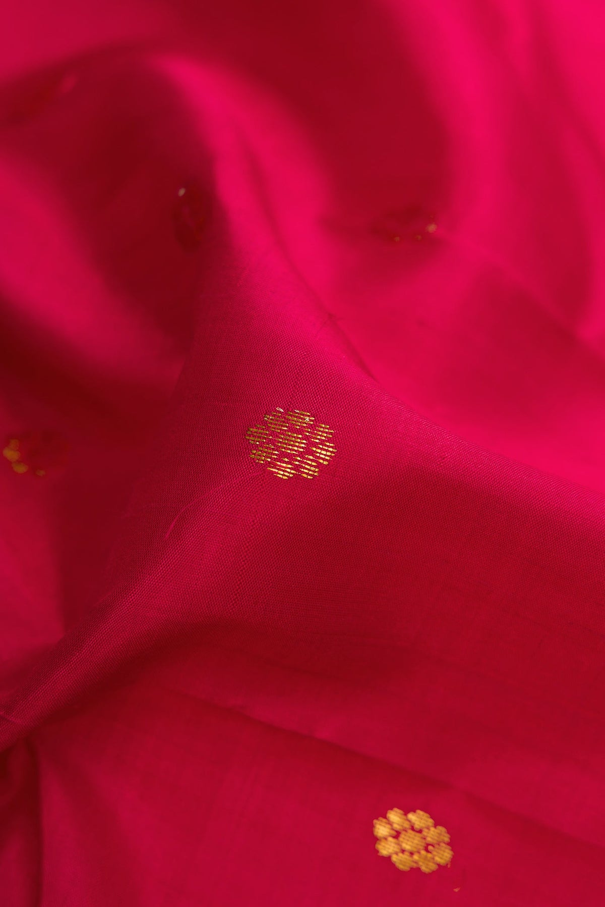 Close up of Maroon Dual Tone Kanchipuram Silk Saree with Zari Butta on the body and Zari Border.  displaying folds