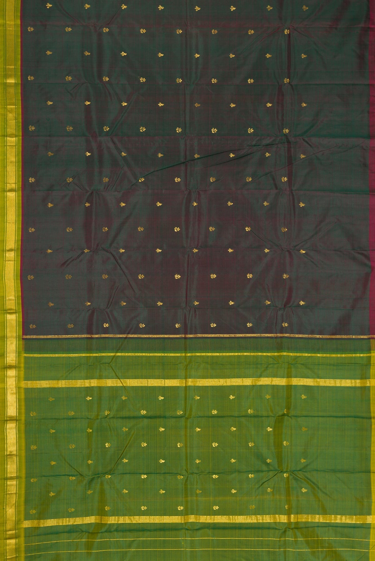 Flat view of Bottle Green Dual Tone Kanchipuram Silk Saree with Zari Butta on the body and Zari Border. 