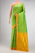 Parrot Green Dual Tone Kanjivaram Silk Saree with Plain Body and Zari Border.  displayed on a mannequin