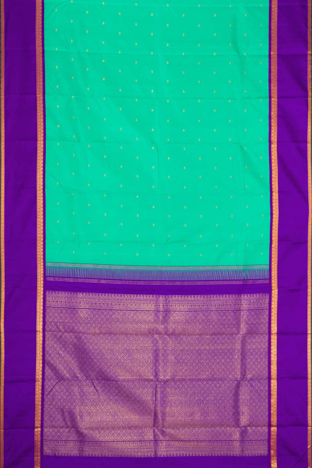 Flat view of Sea Green Dual Tone Kanjivaram Silk Saree with Zari Butta on the body and Zari Border. 