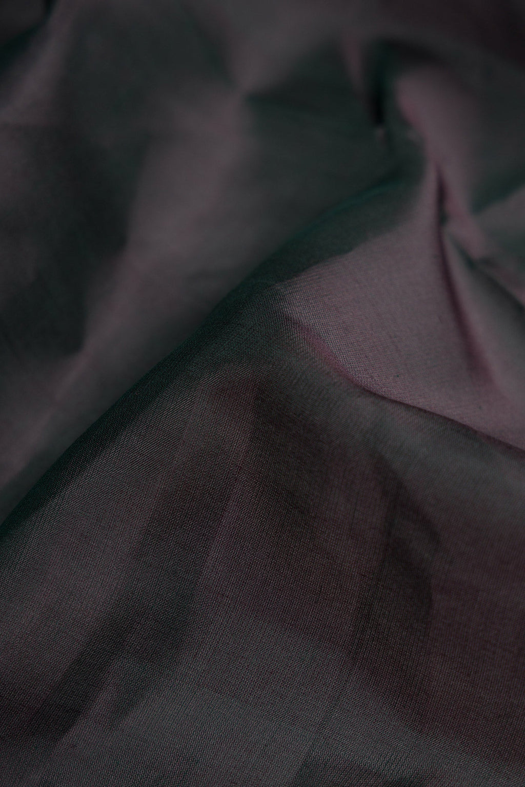 Close up of Black Dual Tone Kanjivaram Silk Nine Yards Saree with Plain Body and Zari Border.  displaying folds