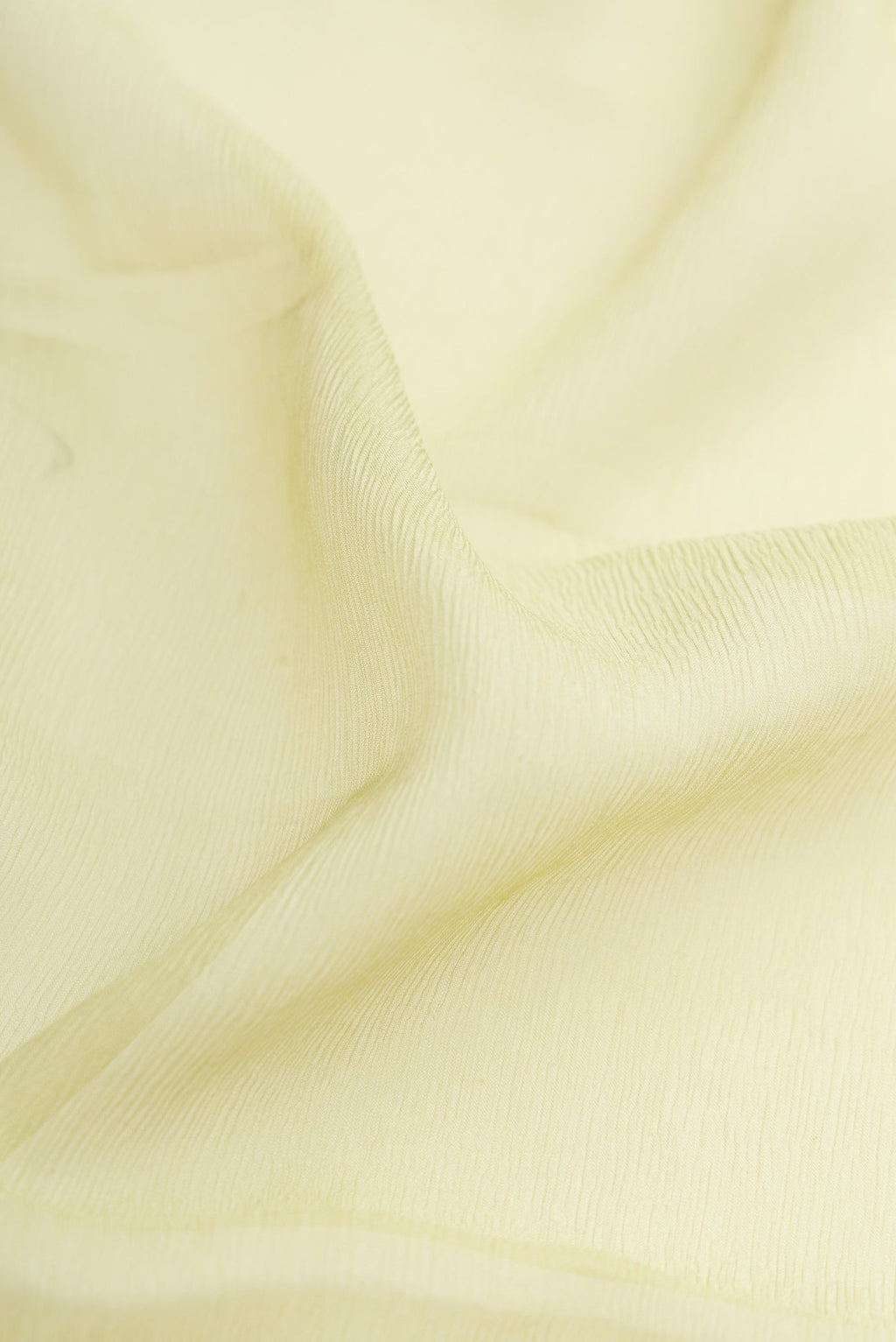 Close up of Pista Green Dual Tone Mysore Chiffon Saree with Plain Body and Plain Border.  displaying folds