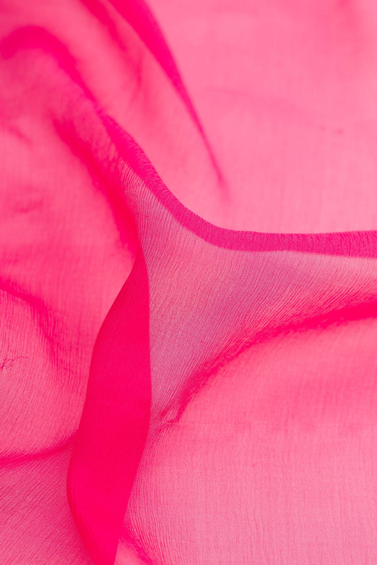 Close up of Pink Dual Tone Mysore Chiffon Saree with Plain Body and Zari Border.  displaying folds