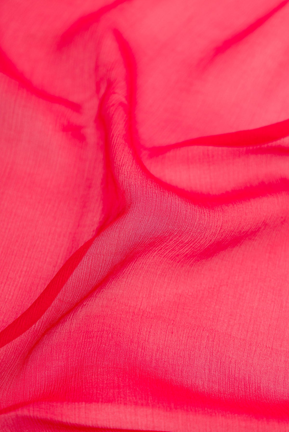 Close up of Red Mysore Chiffon Saree with Plain Body and Zari Border.  displaying folds