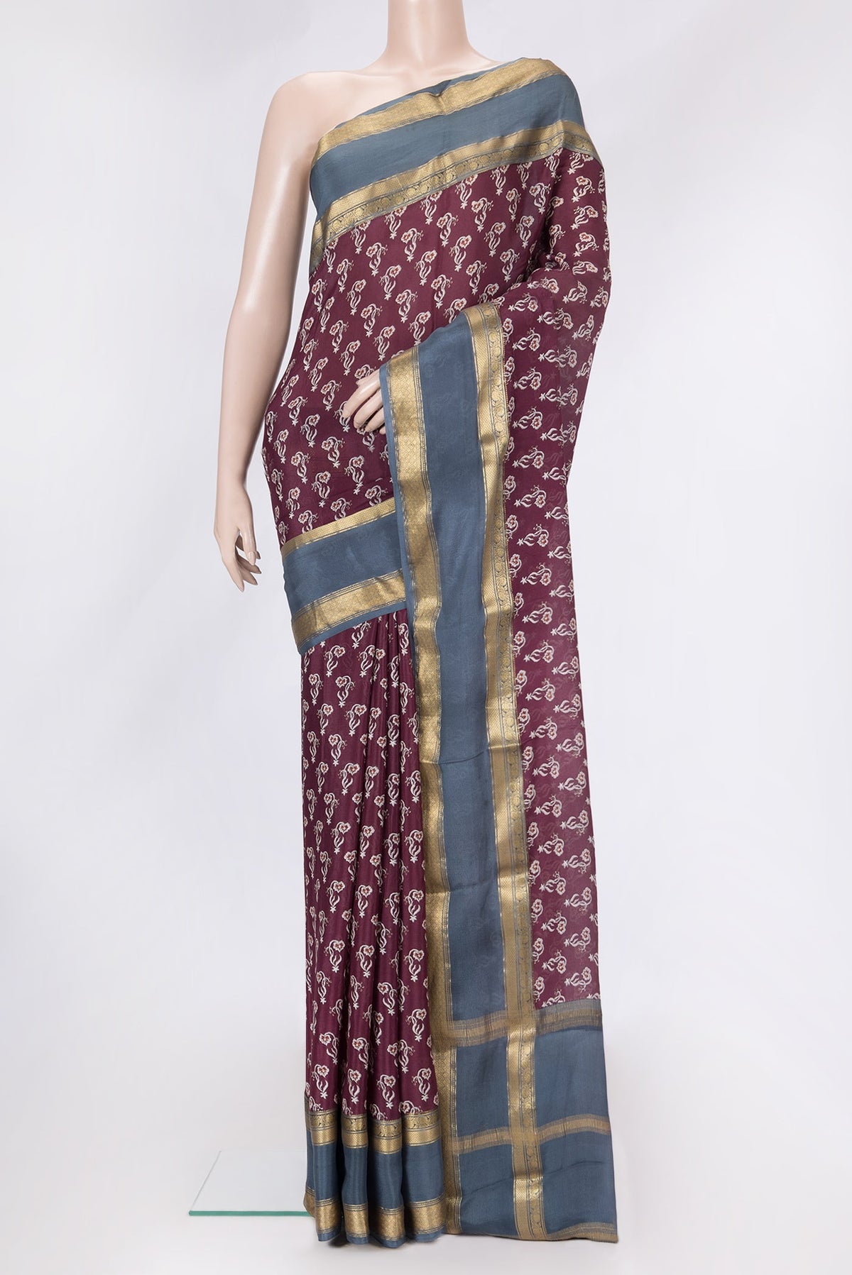 Maroon Dual Tone Mysore Crepe Saree with Printed design on the body and Zari Border.  displayed on a mannequin