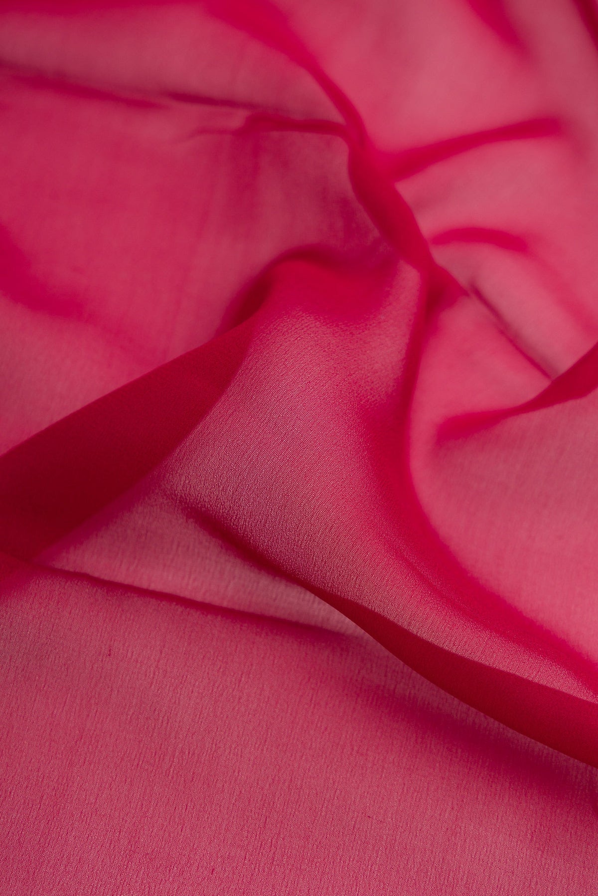 Close up of Maroon Dual Tone Mysore Georgette Saree with Plain Body and Zari Border.  displaying folds