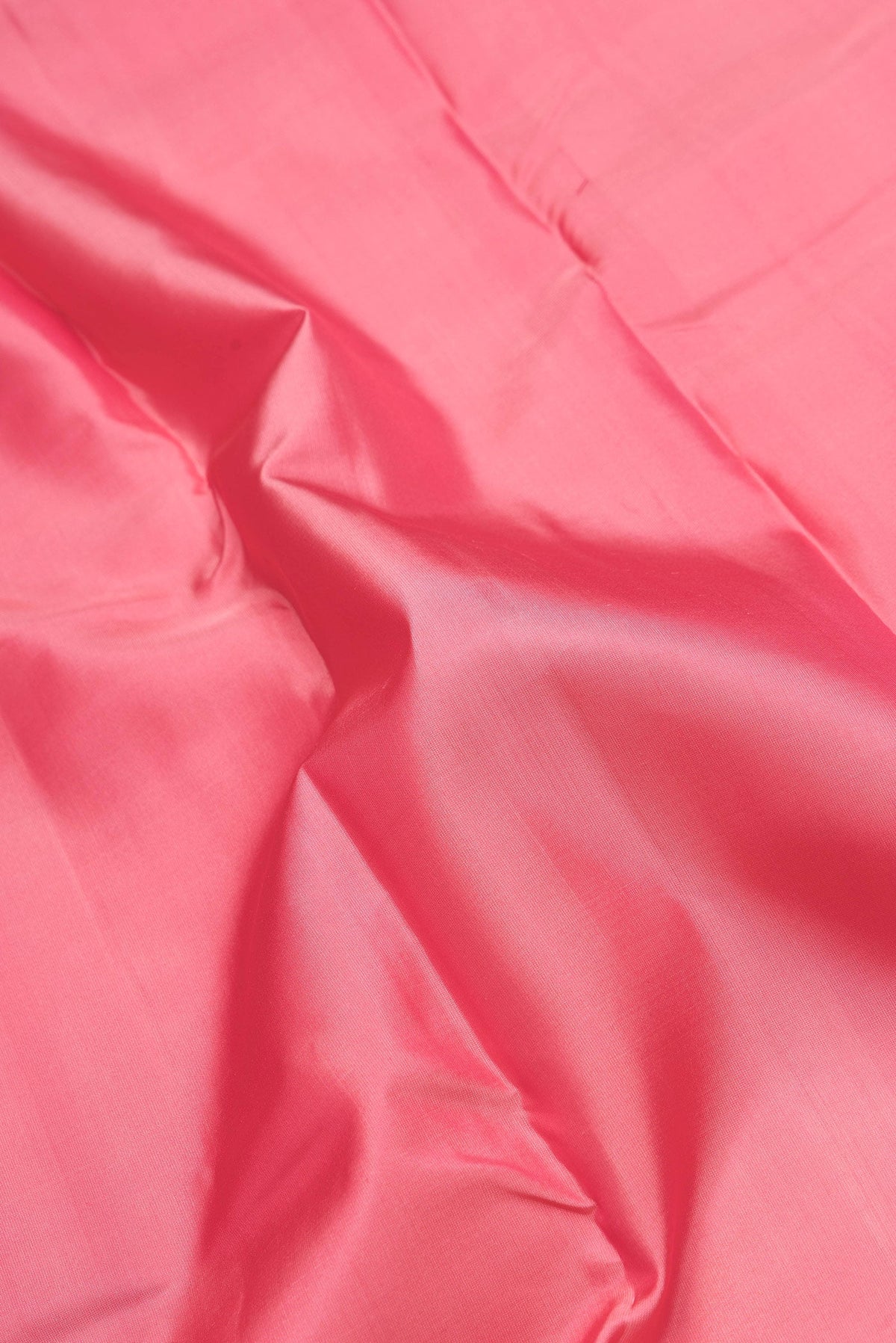 Close up of Pink Dual Tone Kanchipuram Silk Saree with Plain Body and Zari Border.  displaying folds