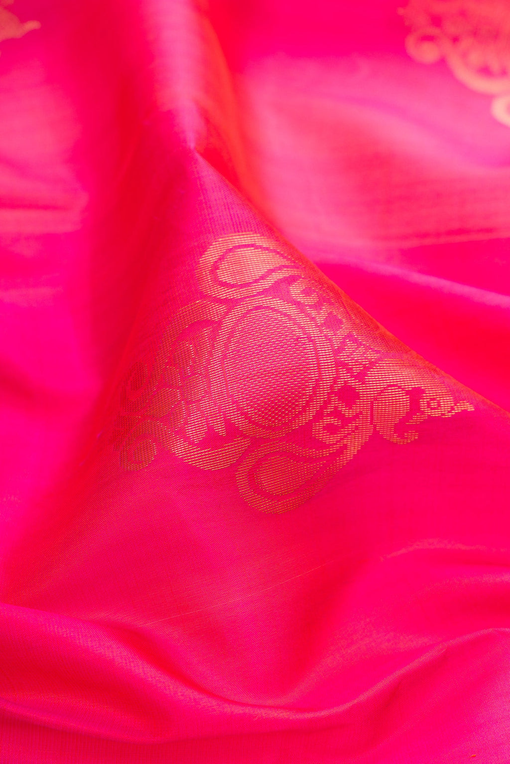 Close up of Pink Soft Silk Saree with Zari Butta on the body and Zari Border.  displaying folds