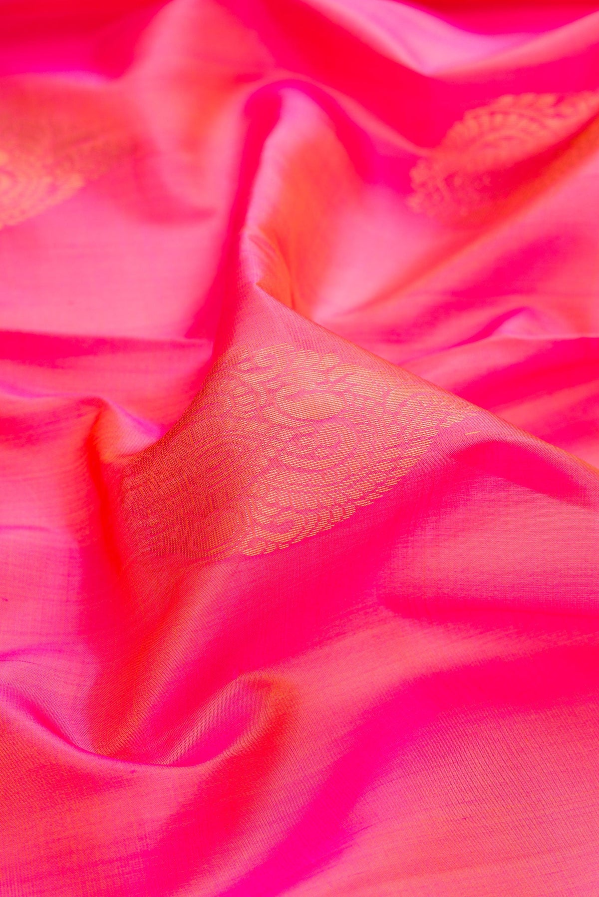 Close up of Pink Dual Tone Soft Silk Saree with Zari Butta on the body and Zari Border.  displaying folds