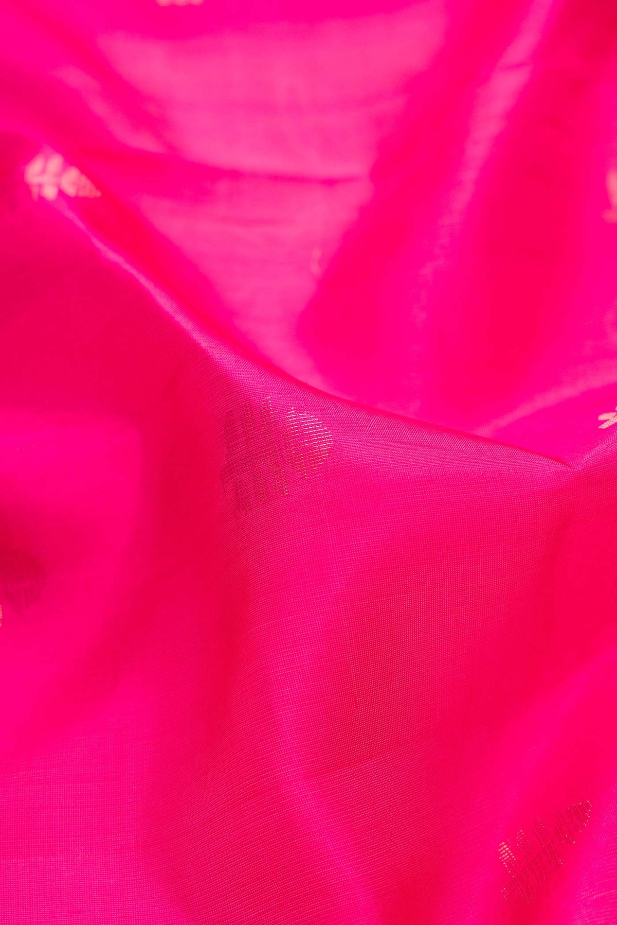Close up of Dark Pink Dual Tone Soft Silk Saree with Zari Butta on the body and Zari Border.  displaying folds