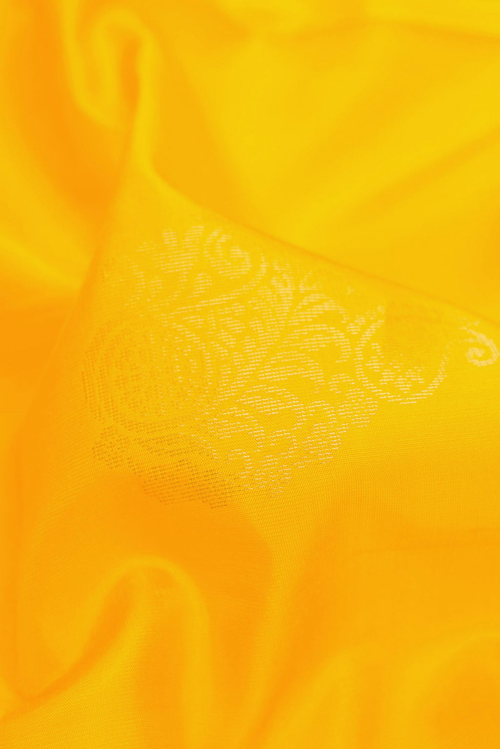 Close up of Yellow Dual Tone Soft Silk Saree with Zari Butta on the body and Zari Border.  displaying folds