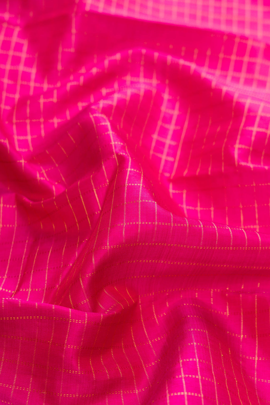 Close up of Pink Dual Tone Kanchipuram Silk Saree with Checked design on the body and Zari Border.  displaying folds