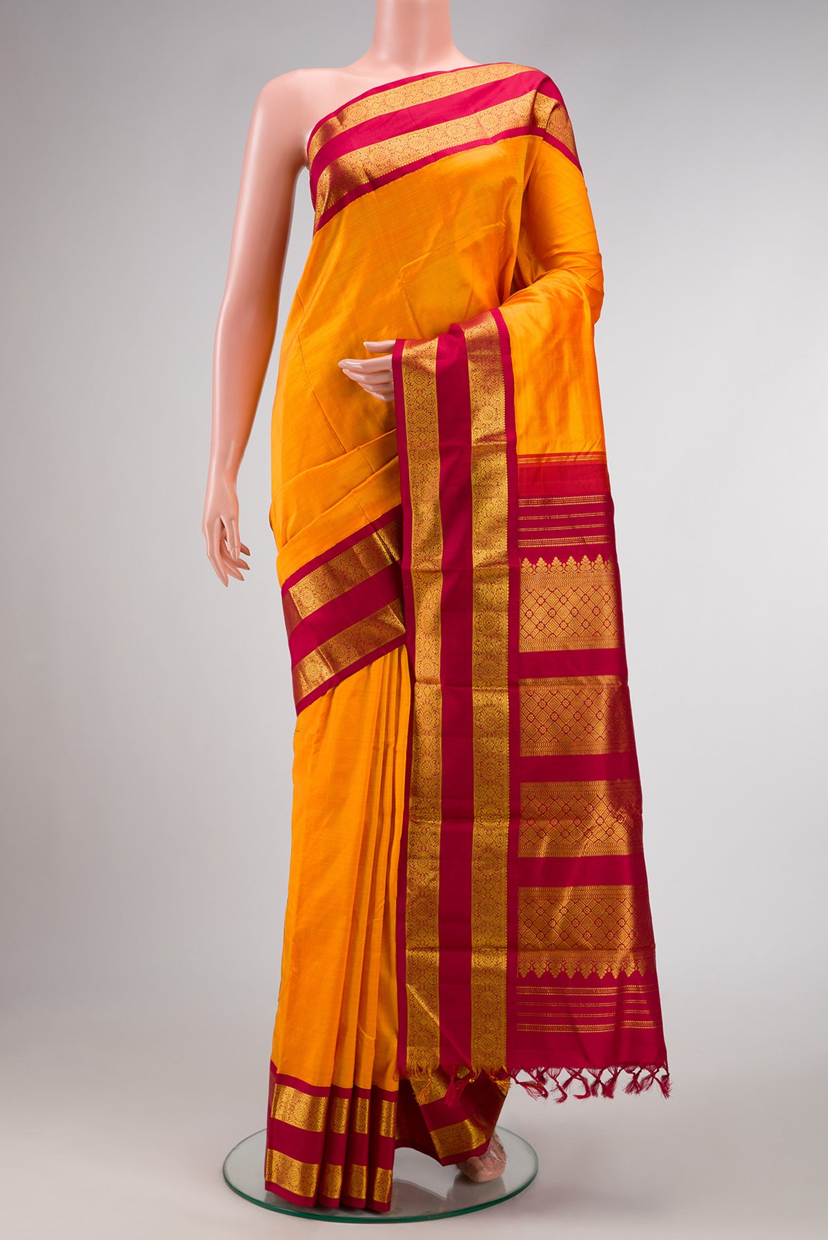 Yellow Dual Tone Kanjivaram Silk Saree with Plain Body and Zari Border.  displayed on a mannequin