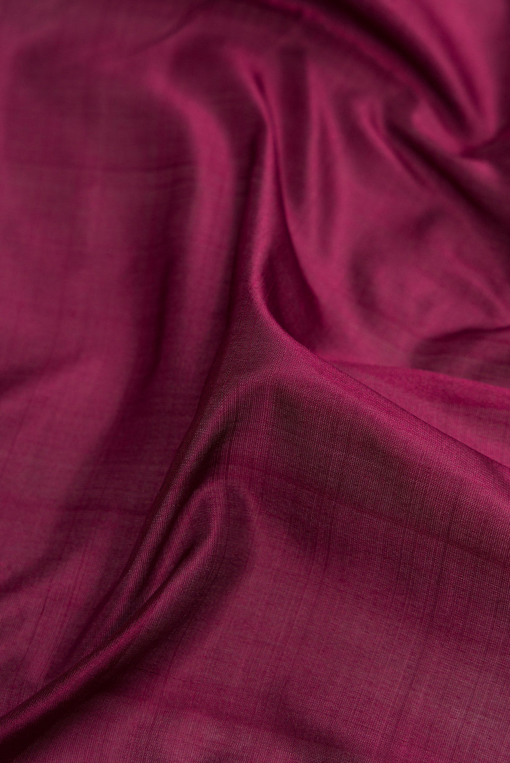 Close up of Burgundy Dual Tone Kanjivaram Silk Nine Yards Saree with Plain Body and Zari Border.  displaying folds