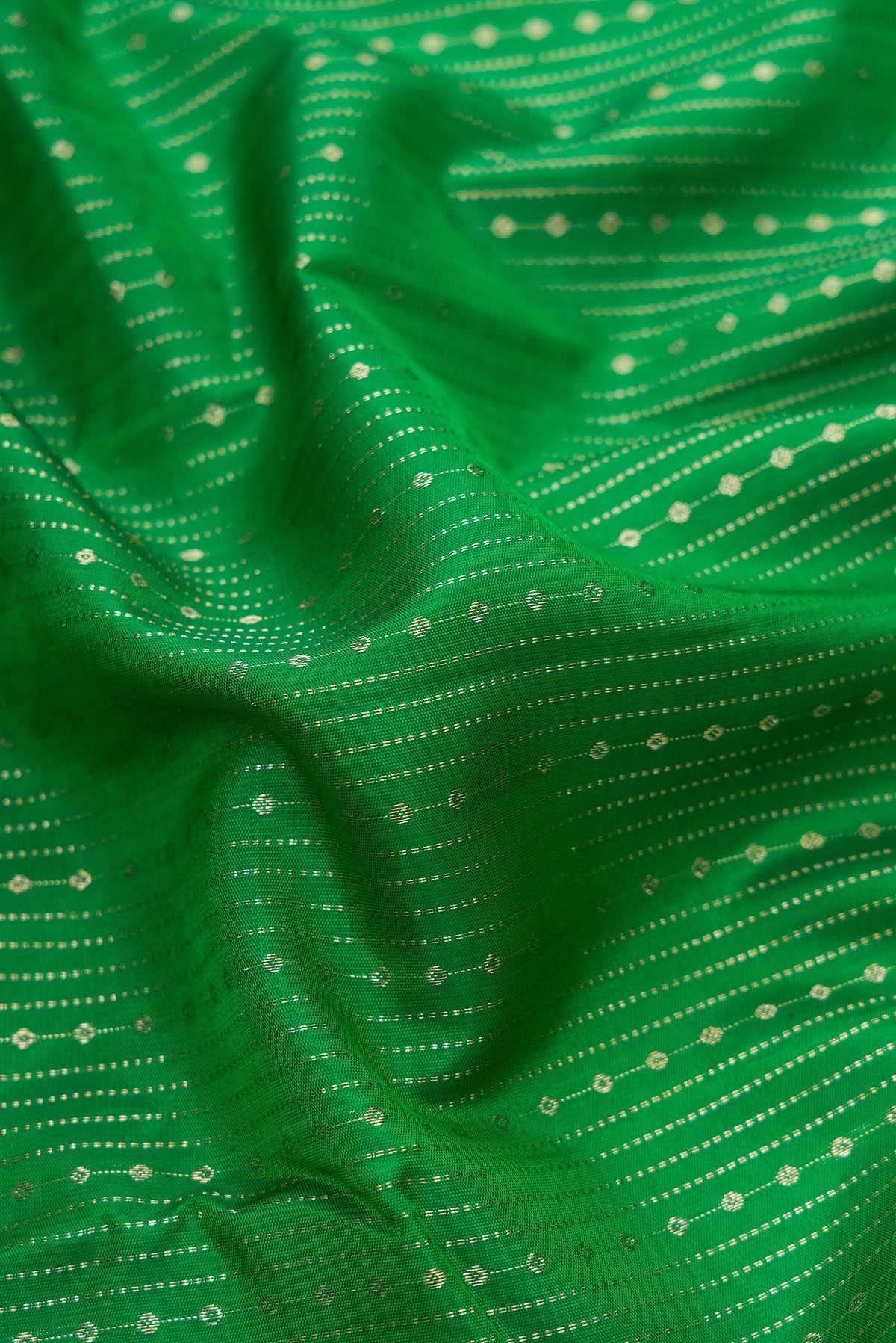 Close up of Bottle Green Dual Tone Kanchipuram Silk Saree with Stripes on the body and Zari Border.  displaying folds