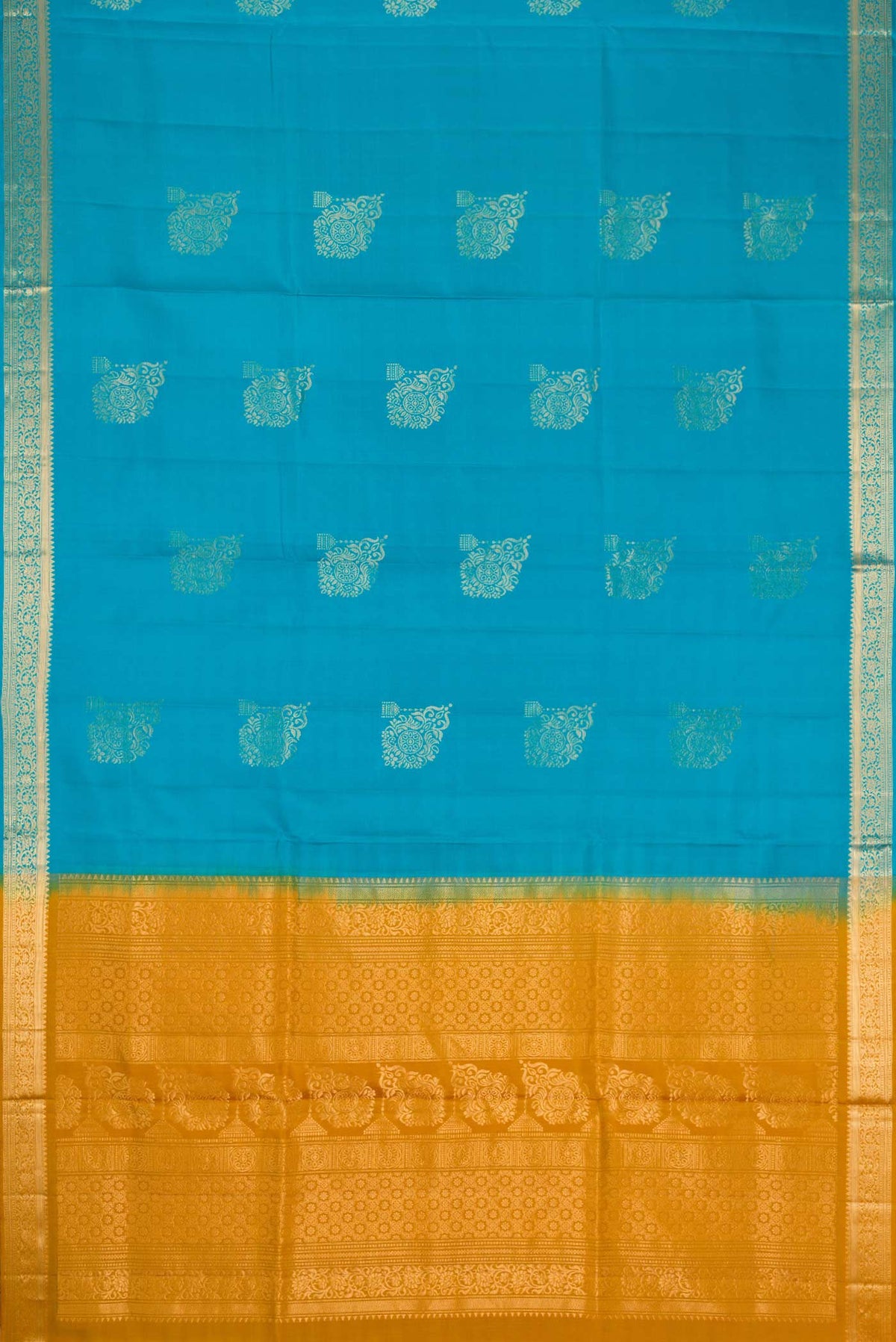 Flat view of Sky Blue Dual Tone Soft Silk Saree with Zari Butta on the body and Zari Border. 