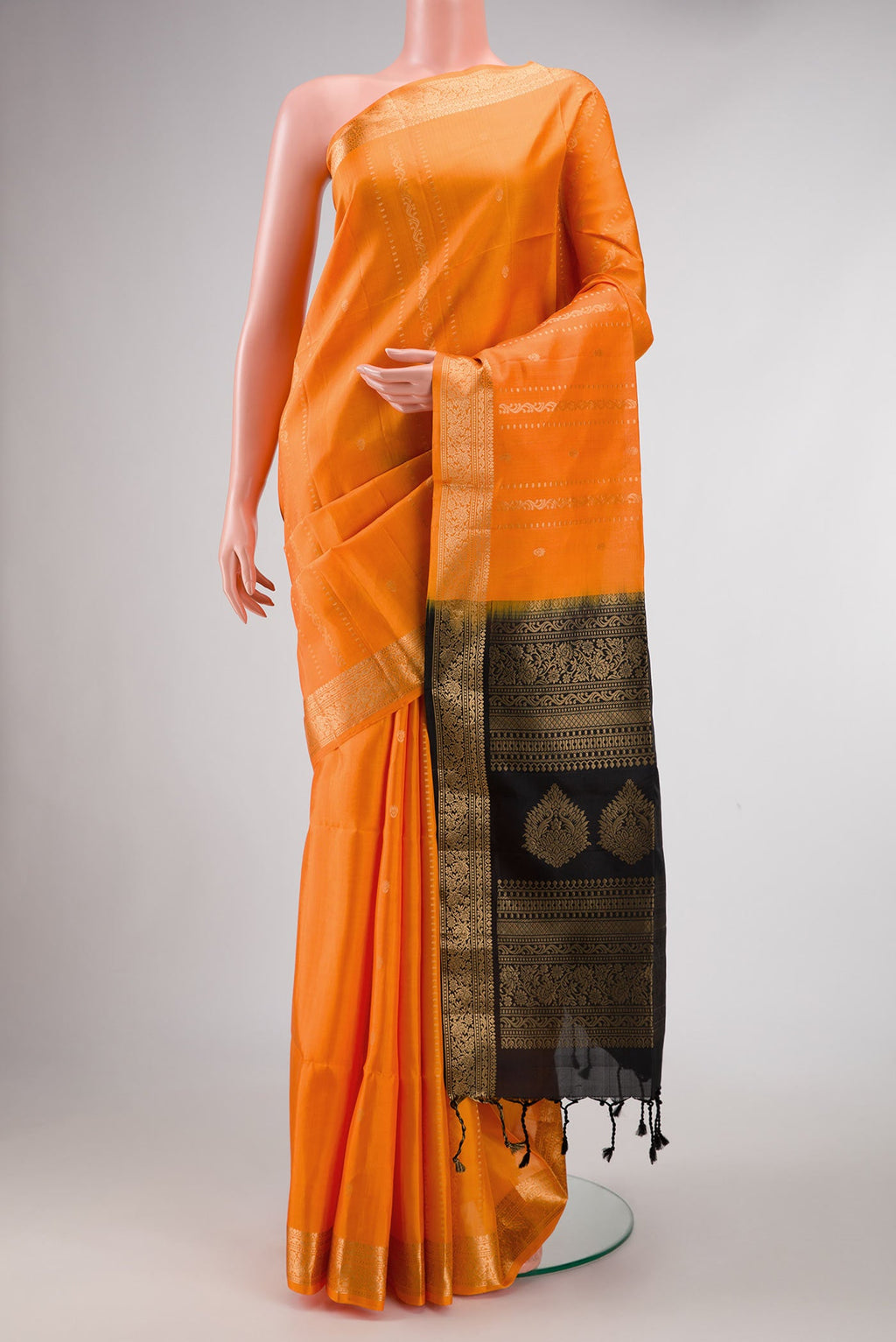 Orange Dual Tone Soft Silk Saree with Stripes on the body and Zari Border displayed on a mannequin