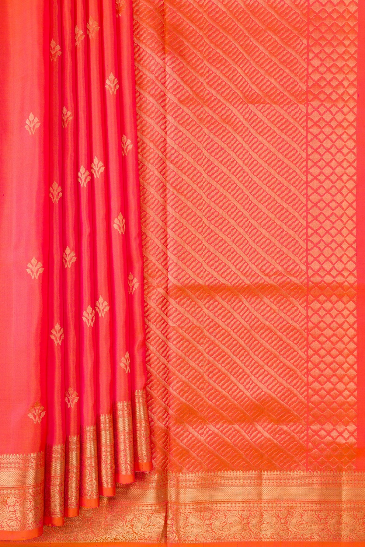 Pleats and pallu of Orange Dual Tone Soft Silk Saree with Zari Butta on the body and Zari Border. 
