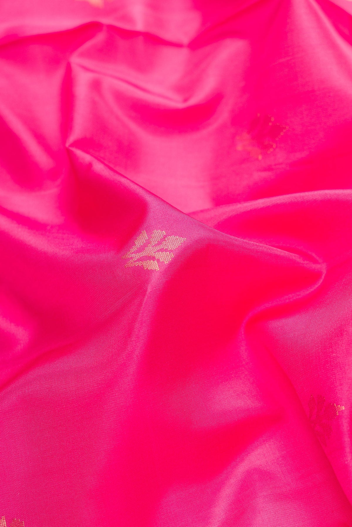 Close up of Pink Dual Tone Soft Silk Saree with Zari Butta on the body and Zari Border.  displaying folds