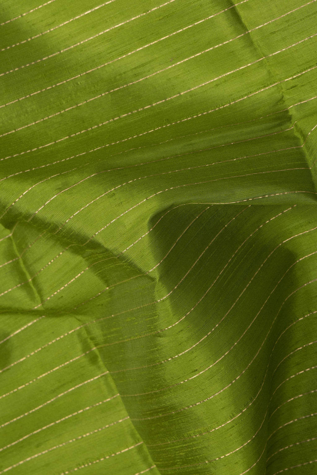 Close up of Green Dual Tone Raw Silk Saree with Stripes on the body and Temple Border.  displaying folds