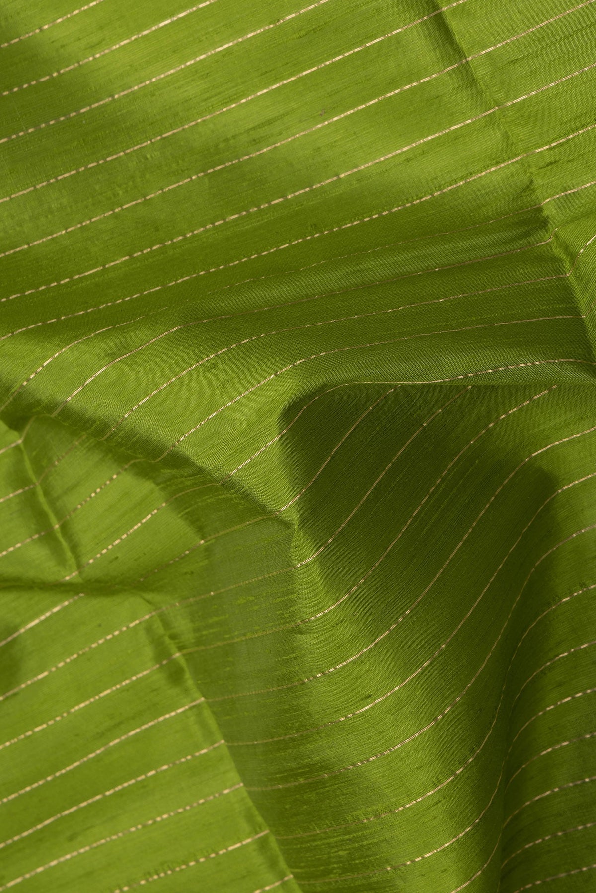 Close up of Green Dual Tone Raw Silk Saree with Stripes on the body and Temple Border.  displaying folds