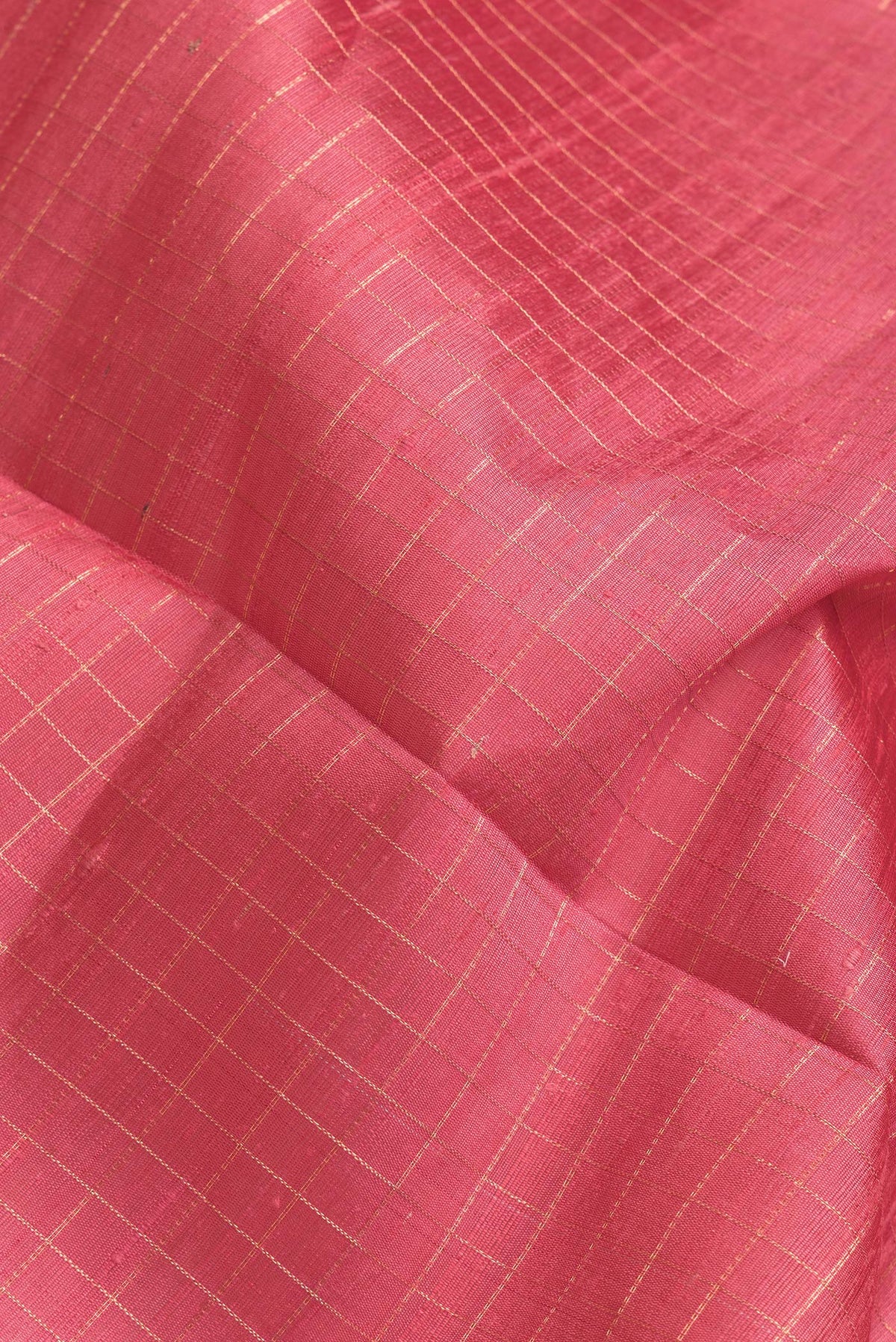 Close up of Pink Dual Tone Raw Silk Saree with Checked design on the body and Zari Border.  displaying folds