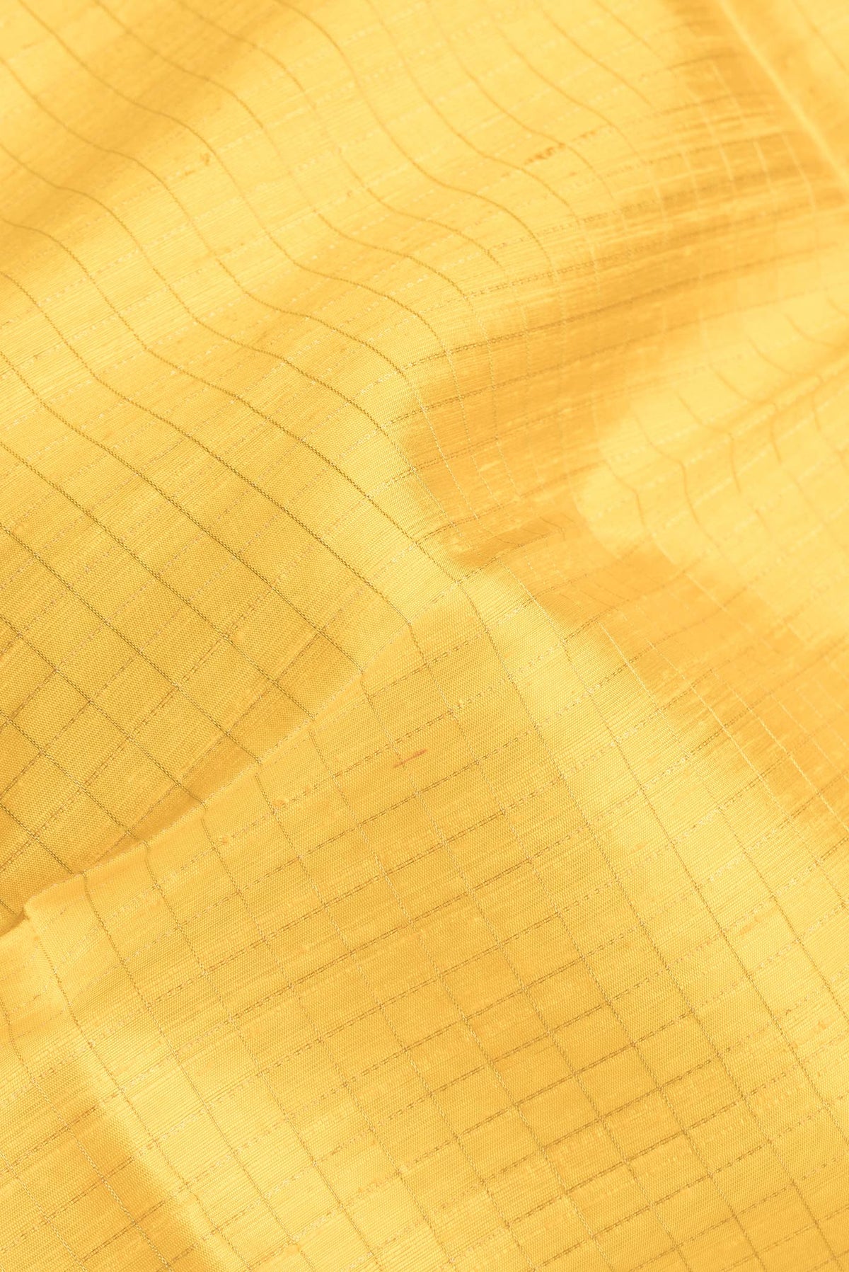 Close up of Yellow Dual Tone Raw Silk Saree with Checked design on the body and Zari Border.  displaying folds