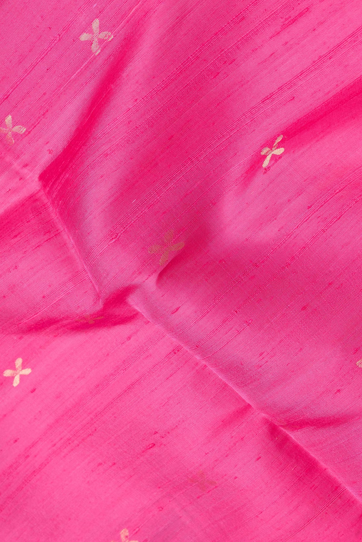 Close up of Pink Dual Tone Raw Silk Saree with Zari Butta on the body and Thin Zari Line.  displaying folds