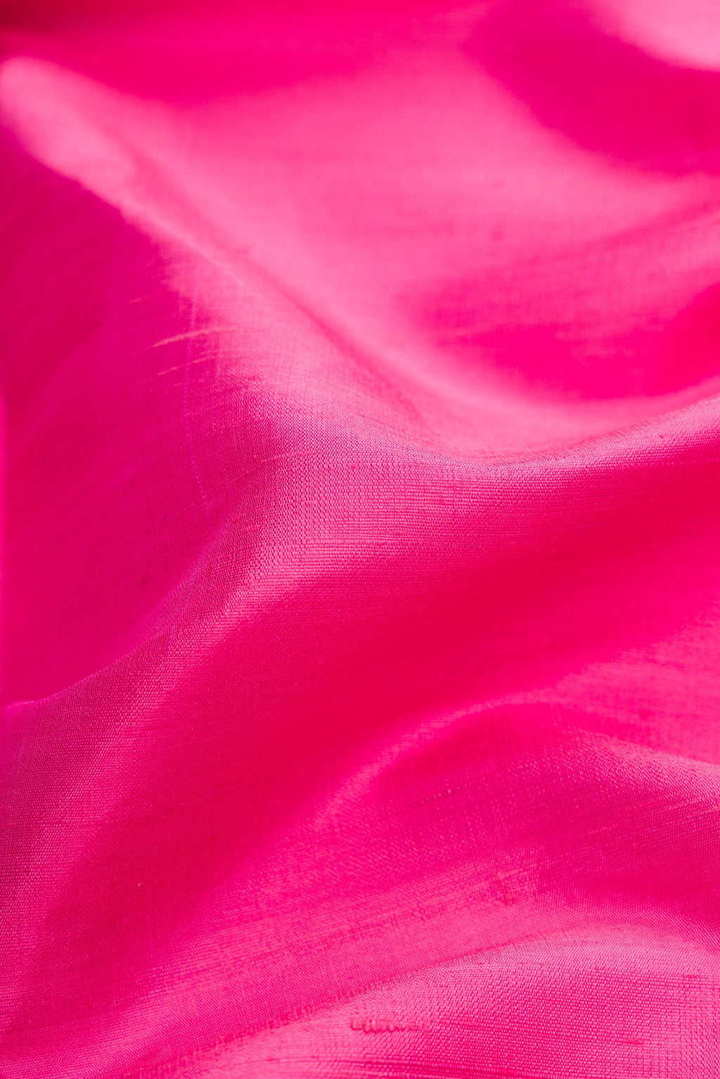 Close up of Pink Dual Tone Raw Silk Saree with Zari Butta on the body and Zari Border.  displaying folds