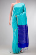 Sky Blue Dual Tone Raw Silk Saree with Zari Butta on the body and Thin Zari Line.  displayed on a mannequin