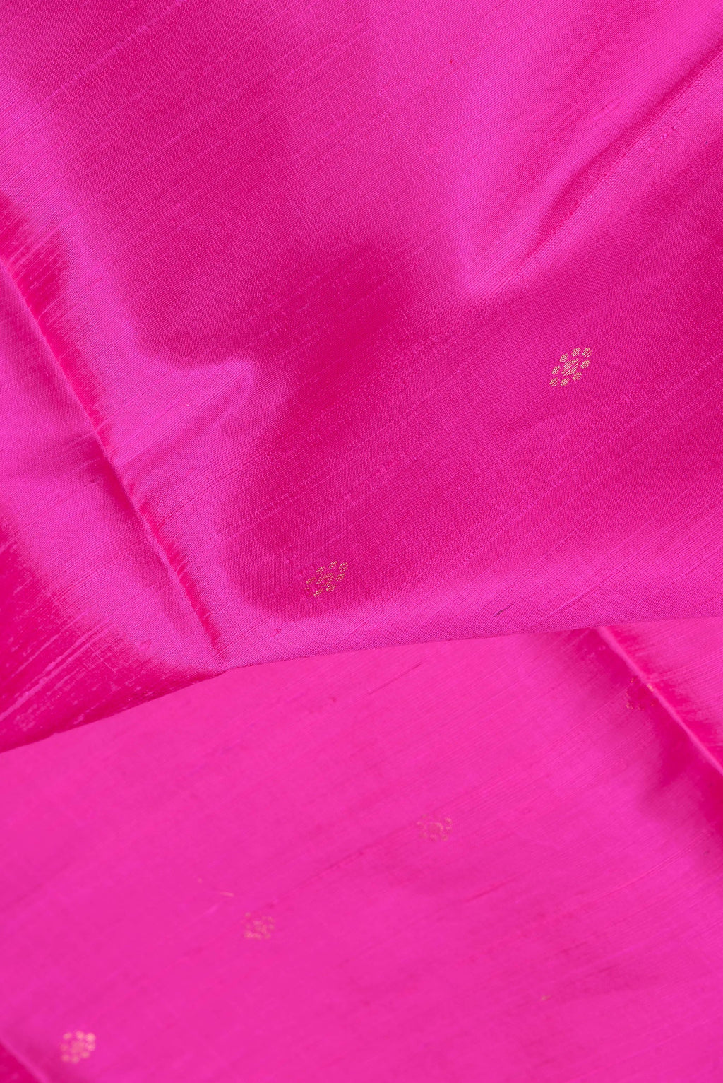 Close up of Dark Pink Dual Tone Raw Silk Saree with Zari Butta on the body and Fancy Border.  displaying folds