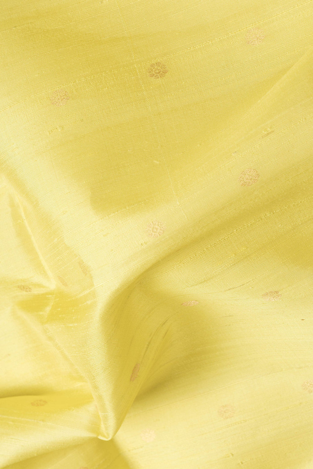 Close up of Lemon Yellow Dual Tone Raw Silk Saree with Zari Butta on the body and Zari Border.  displaying folds