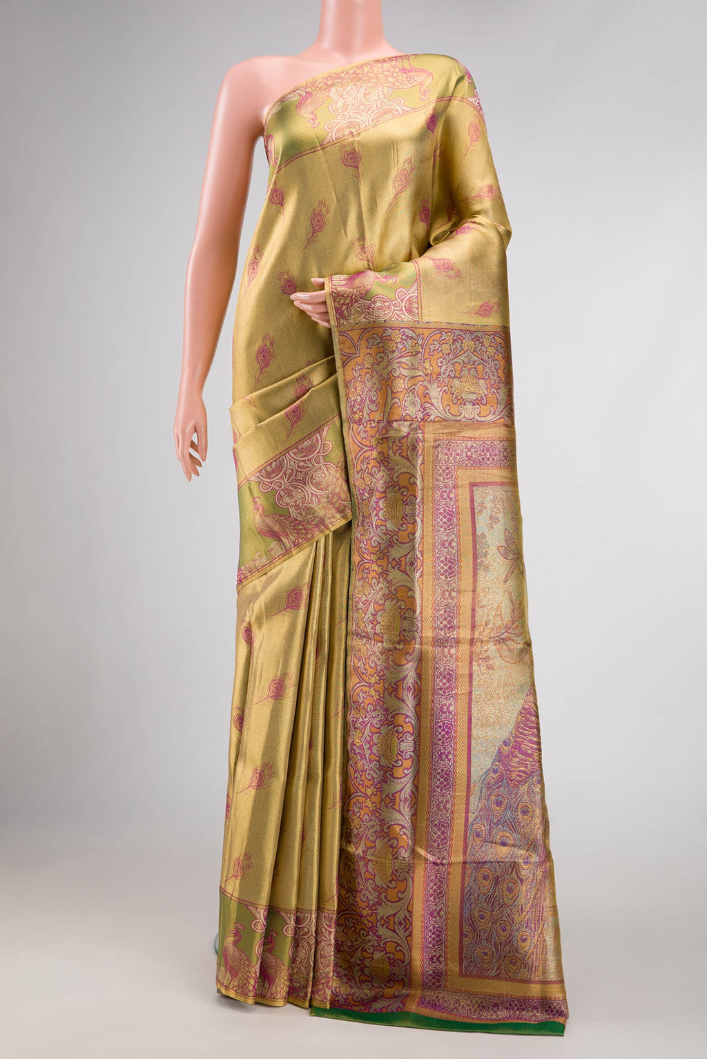 Gold Dual Tone Kanjivaram Tissue Silk Saree with Zari Brocade on the body and Fancy Border.  displayed on a mannequin