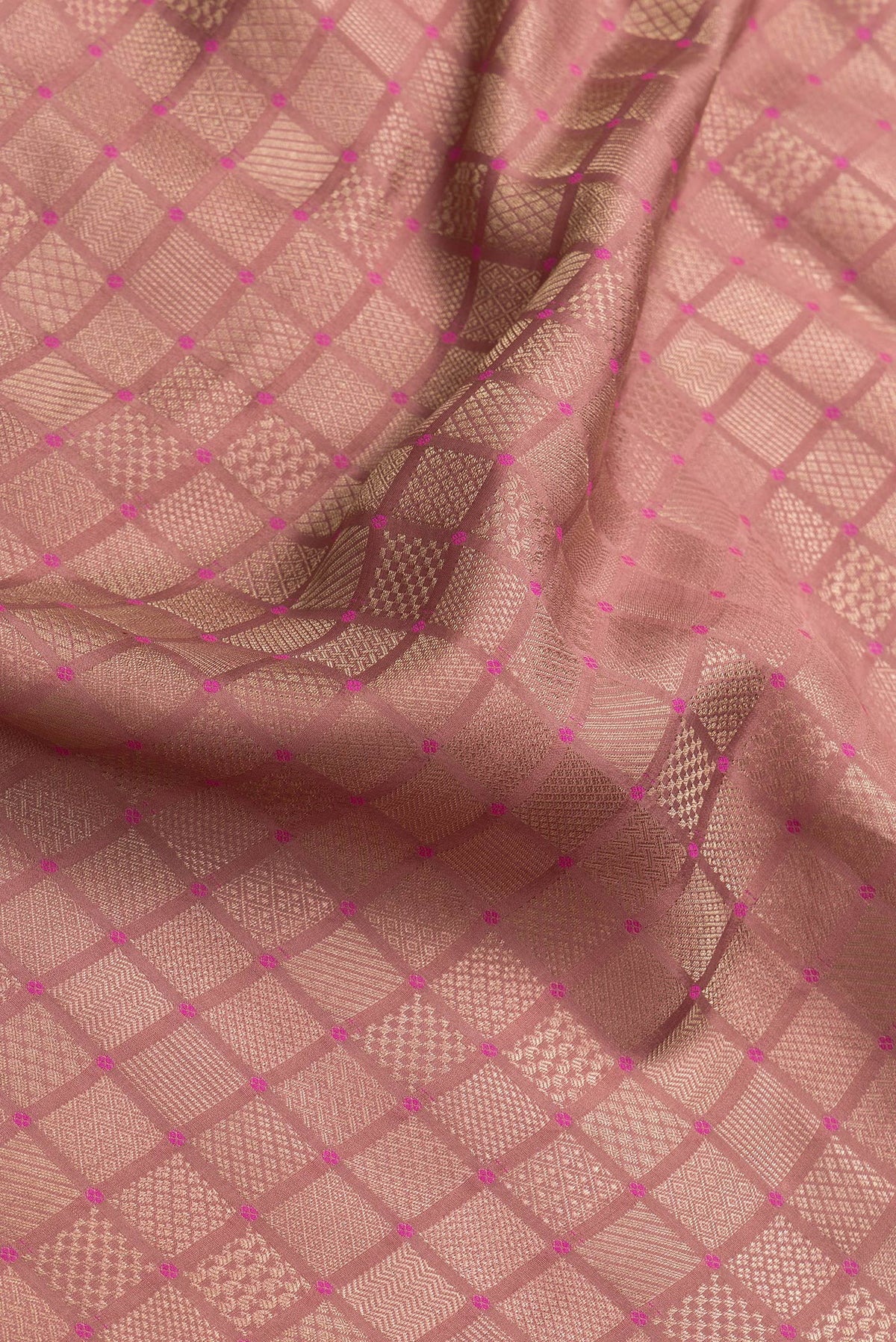 Close up of Brown Dual Tone Mysore Silk Saree with Zari Brocade on the body and Embroidery Border.  displaying folds