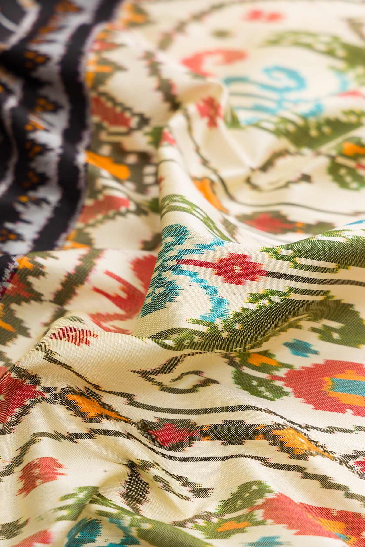 Close up of Beige Dual Tone Double Ikat Saree with Printed design on the body and Paithani Border displaying folds