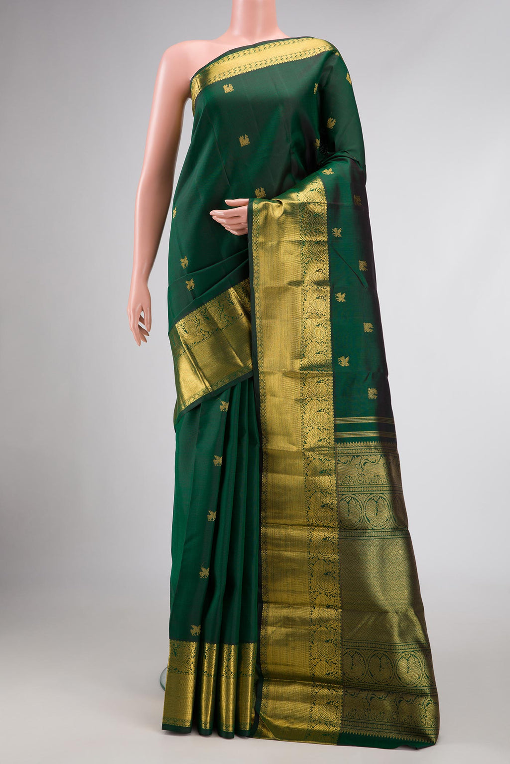 Pure Silk Pure Zari Bottle Green Dual Tone Kanjivaram Saree with Zari Butta on the body and Zari Border.  displayed on a mannequin