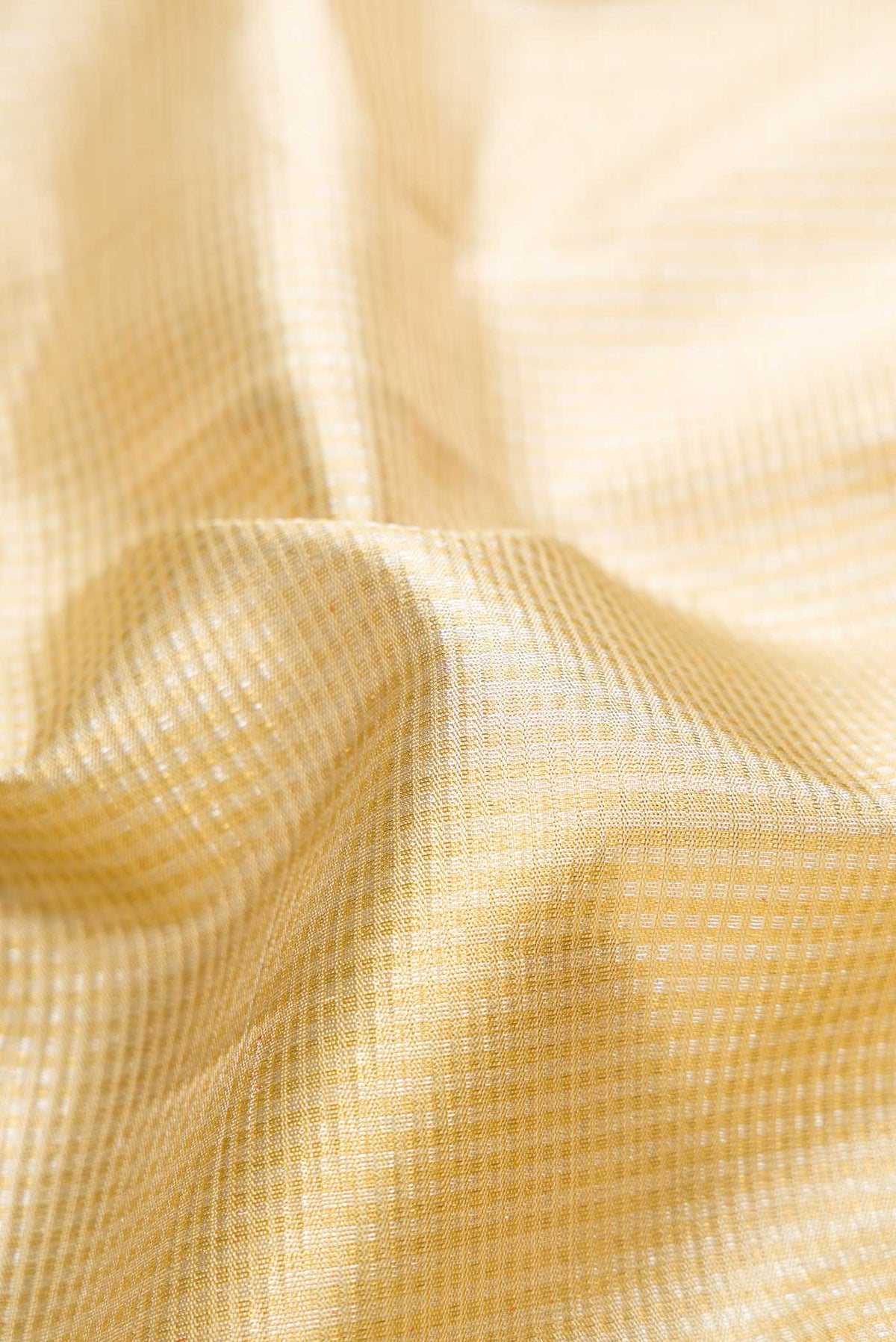 Close up of Pure Silk Pure Zari Gold Dual Tone Kanjivaram Saree with Zari Brocade on the body and Zari Border.  displaying folds