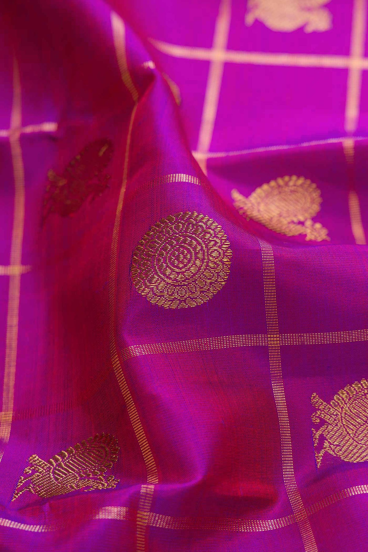 Close up of Pure Silk Pure Zari Purple Dual Tone Kanchipuram Saree with Checked design on the body and Zari Border displaying folds