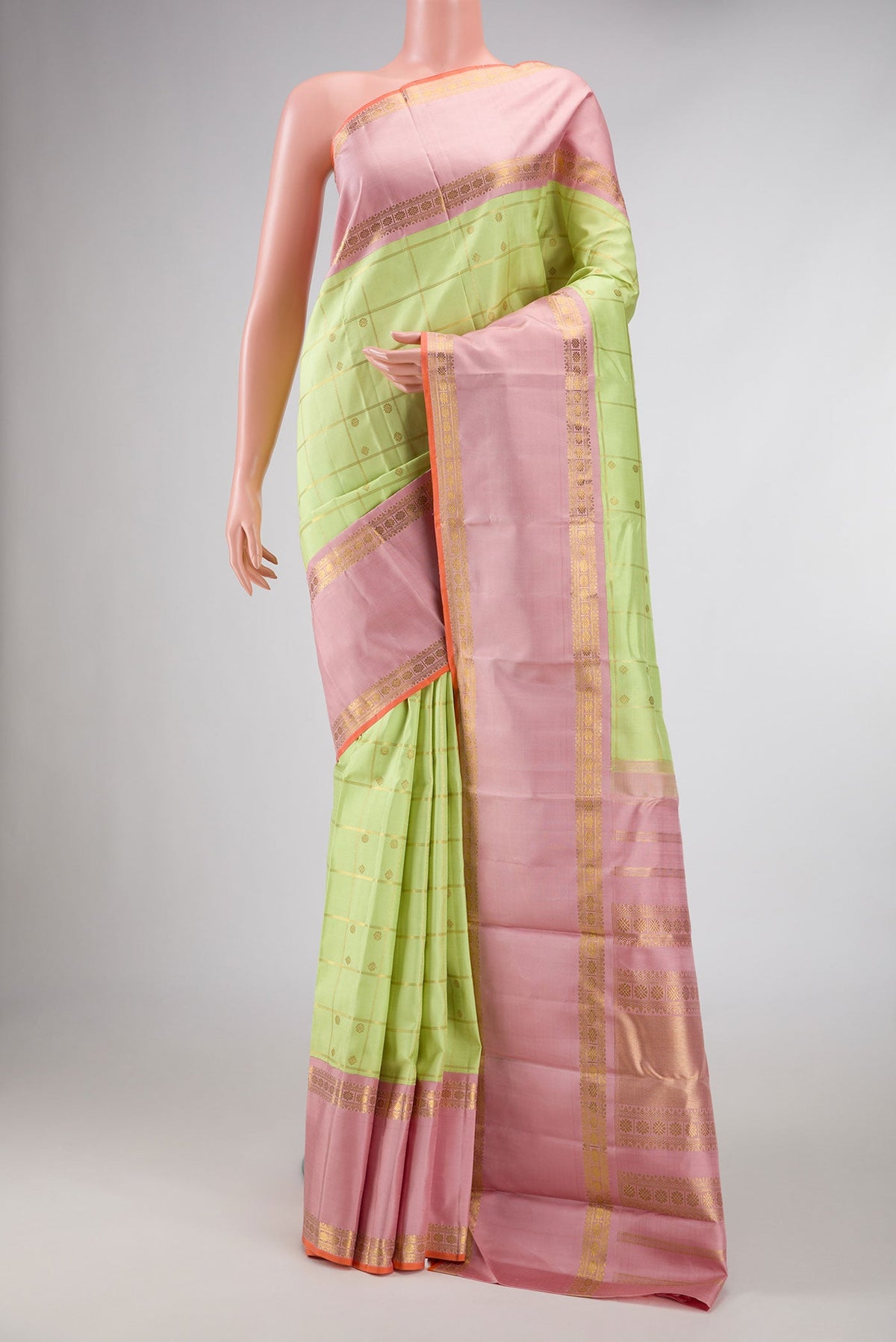 Pure Silk Pure Zari Parrot Green Dual Tone Kanchipuram Saree with Checked design on the body and Zari Border displayed on a mannequin