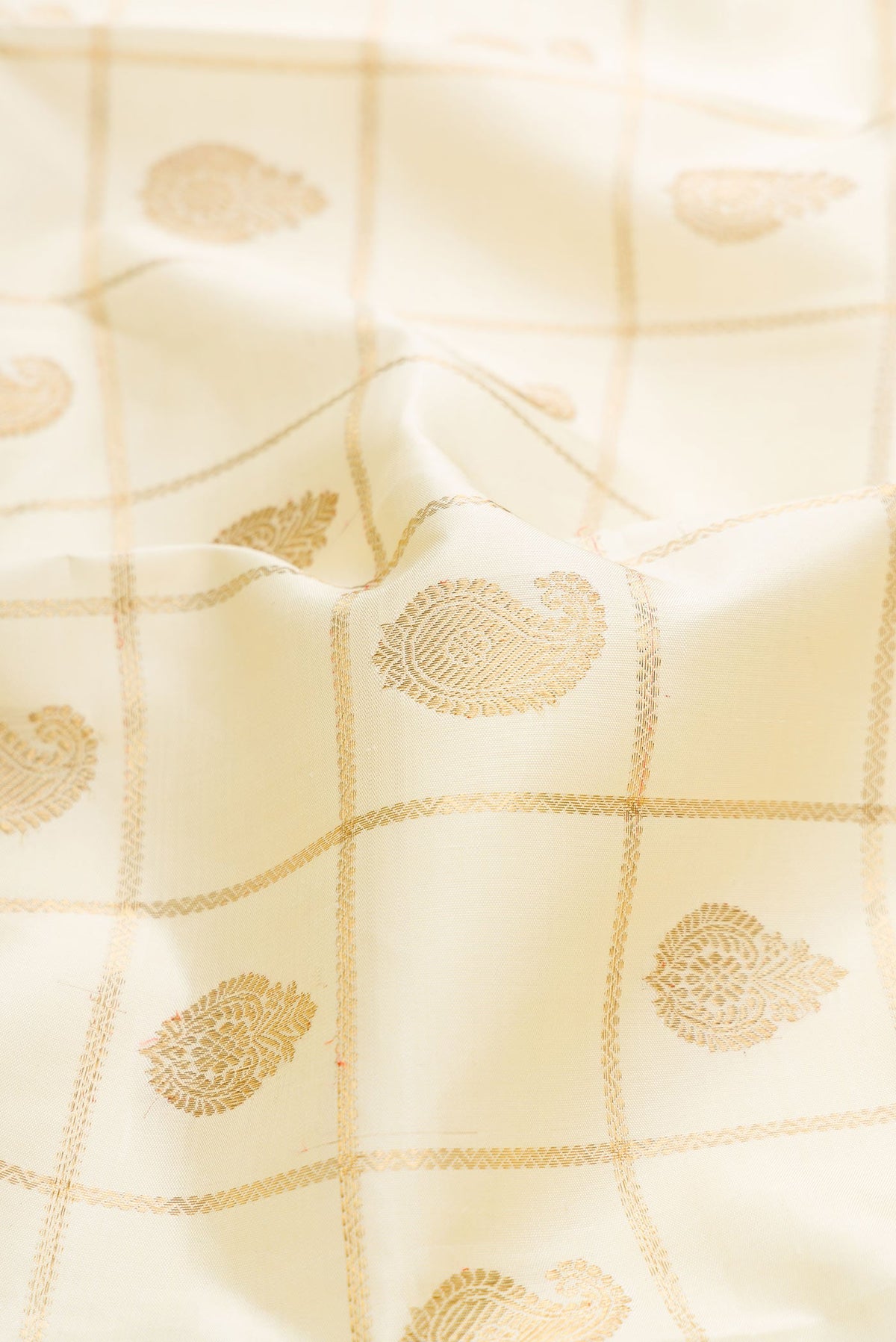 Close up of Pure Silk Pure Zari Sandal Dual Tone Kanchipuram Saree with Checked design on the body and Zari Border displaying folds