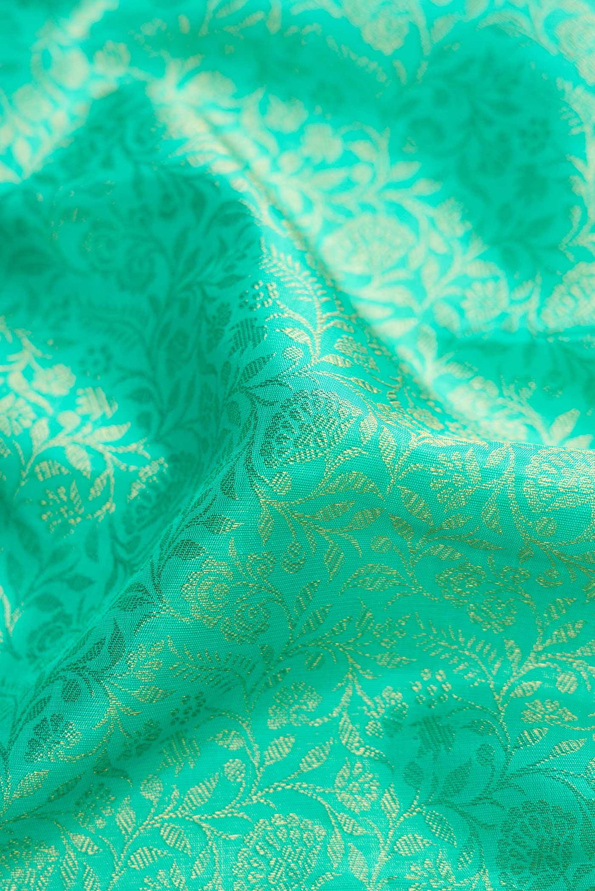 Close up of Pure Silk Pure Zari Sea Green Dual Tone Kanchipuram Saree with Zari Brocade on the body and Zari Border displaying folds