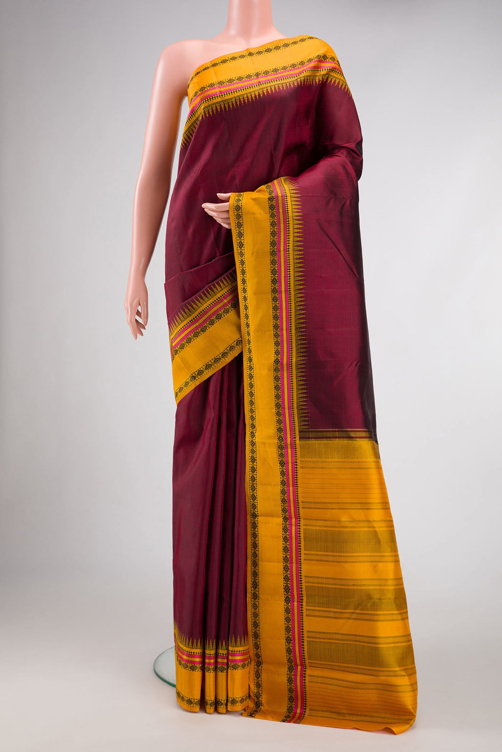 Maroon Dual Tone Kanjivaram Silk Saree with Plain Body and Thread Border.  displayed on a mannequin