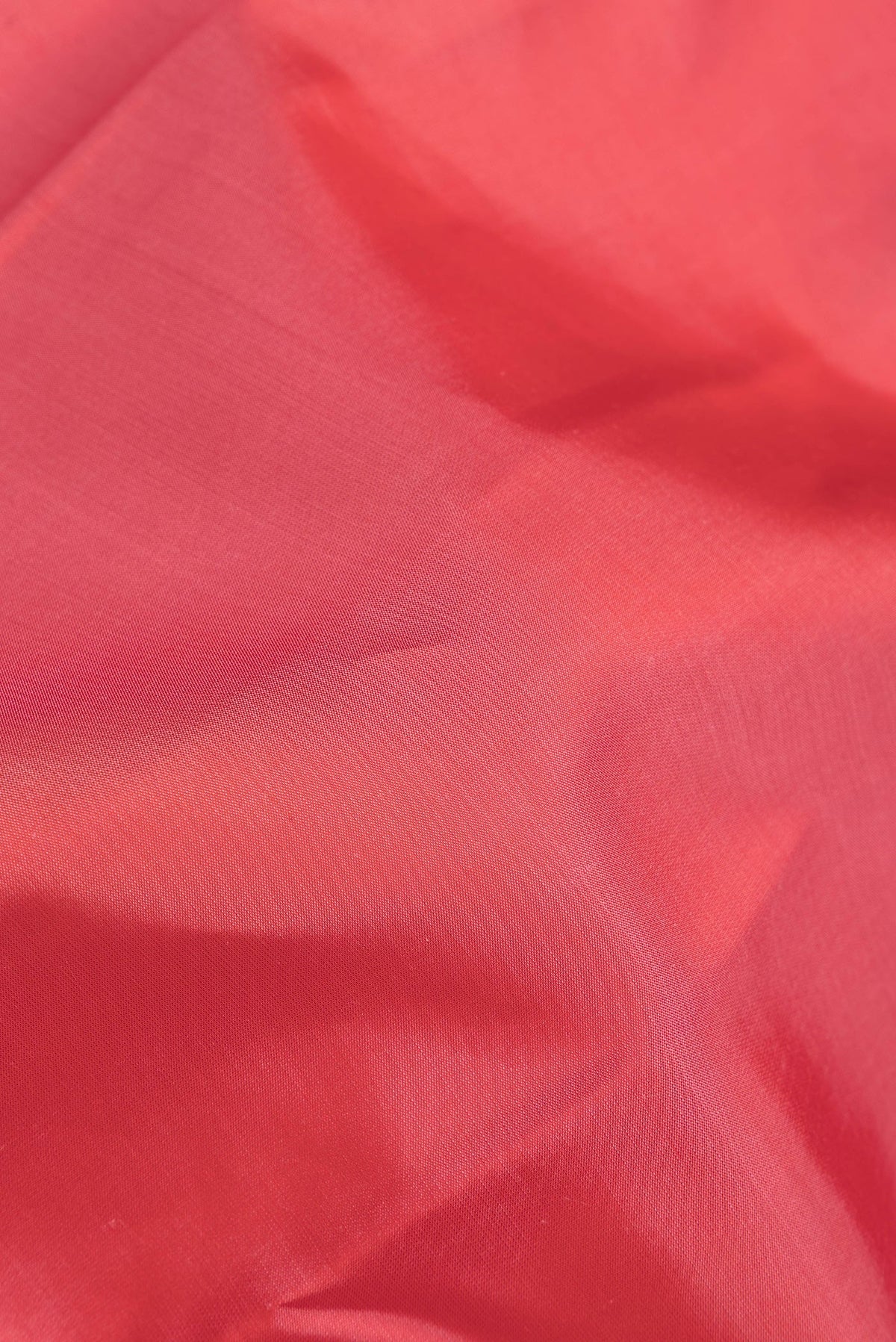 Close up of Pink Dual Tone Kanjivaram Silk Saree with Zari Butta on the body and Zari Border.  displaying folds