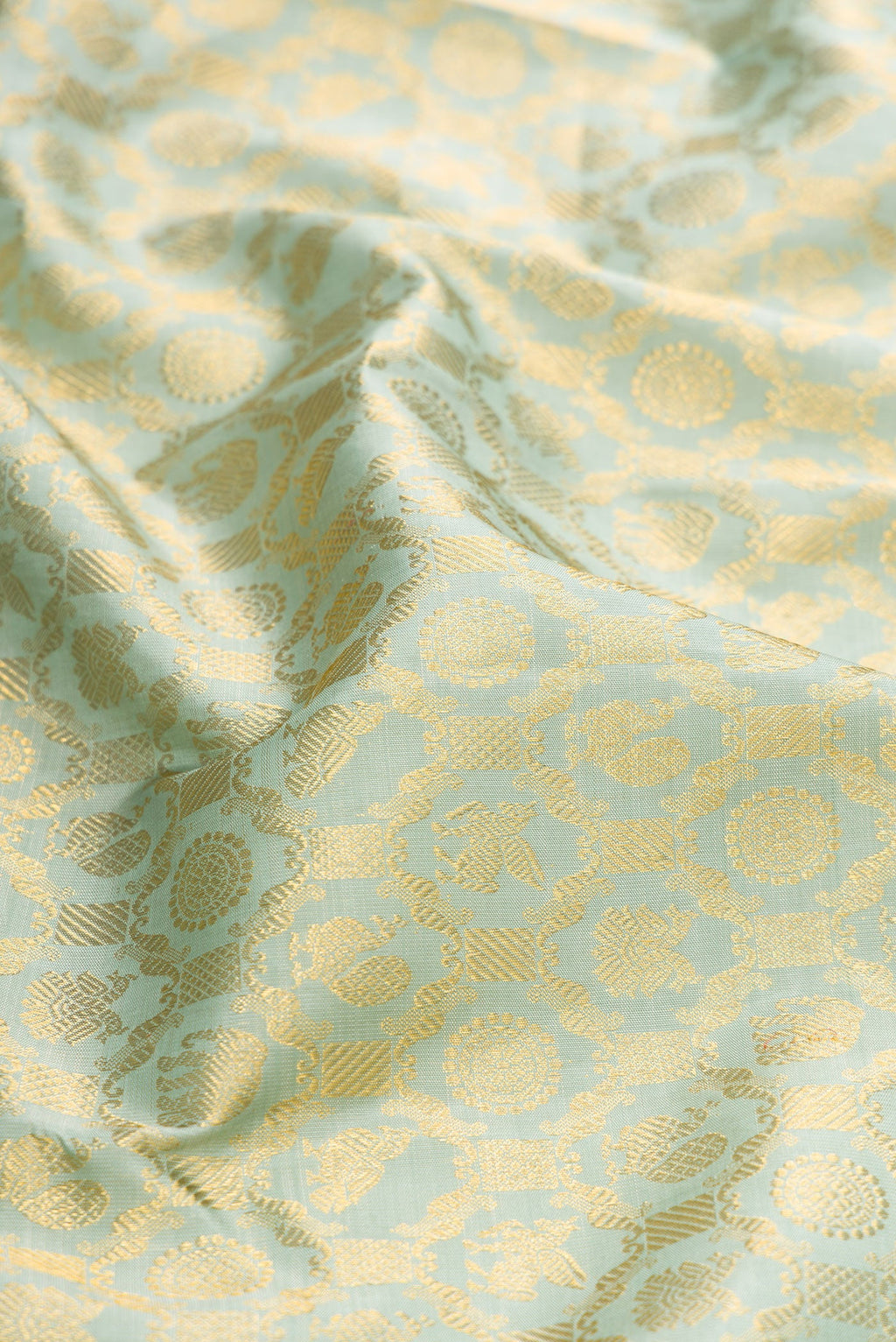 Close up of Pista Green Dual Tone Kanchipuram Silk Saree with Zari Brocade on the body and Zari Border.  displaying folds