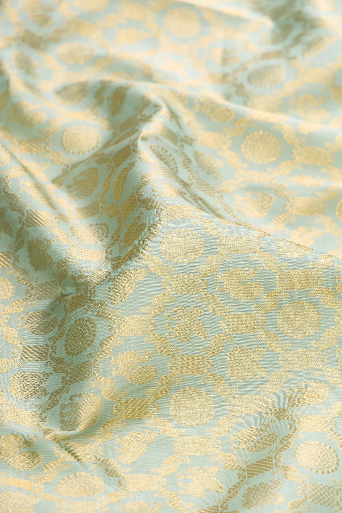Close up of Pista Green Dual Tone Kanchipuram Silk Saree with Zari Brocade on the body and Zari Border.  displaying folds