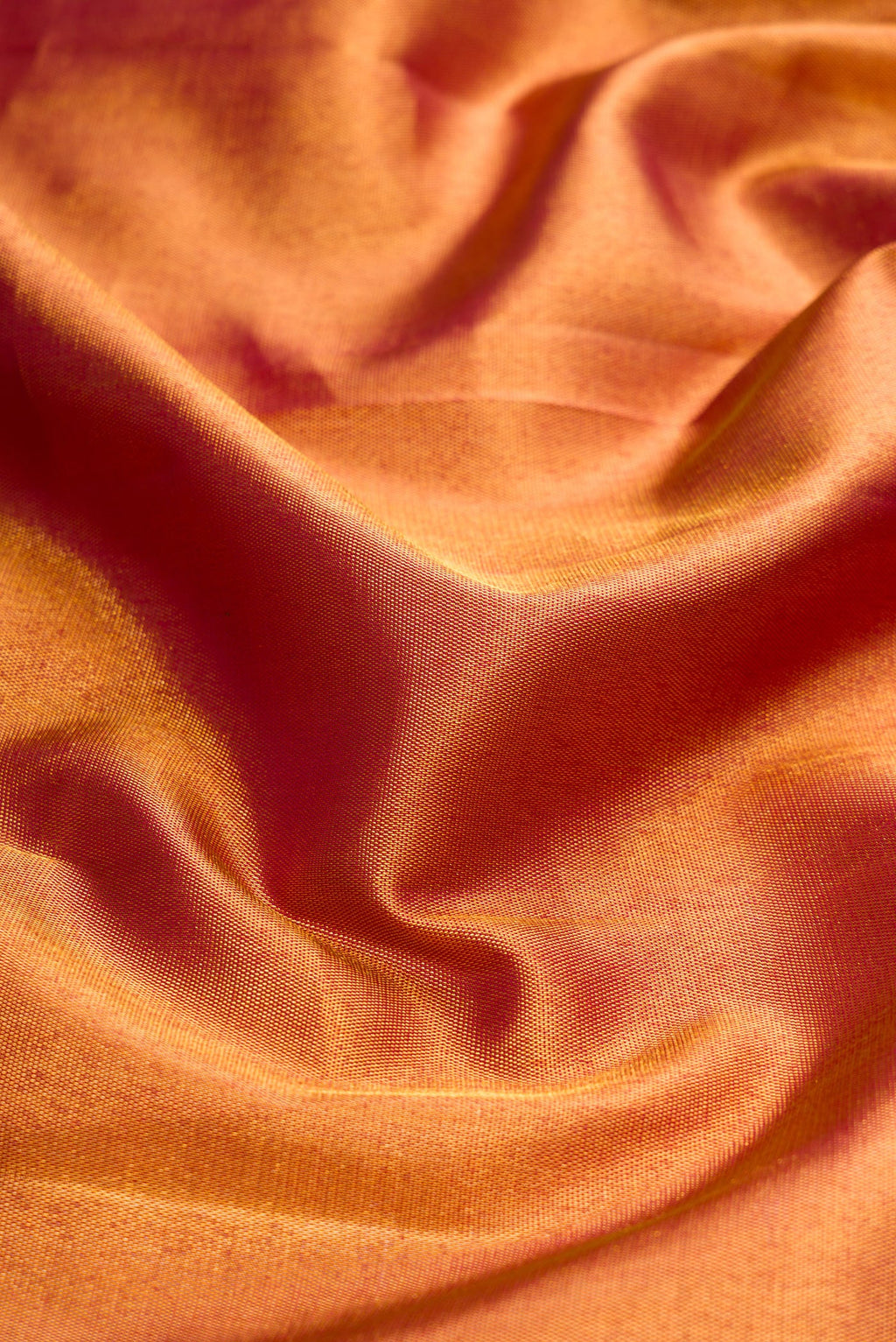 Close up of Maroon Dual Tone Kanjivaram Silk Saree with Zari Brocade on the body and Zari Border.  displaying folds