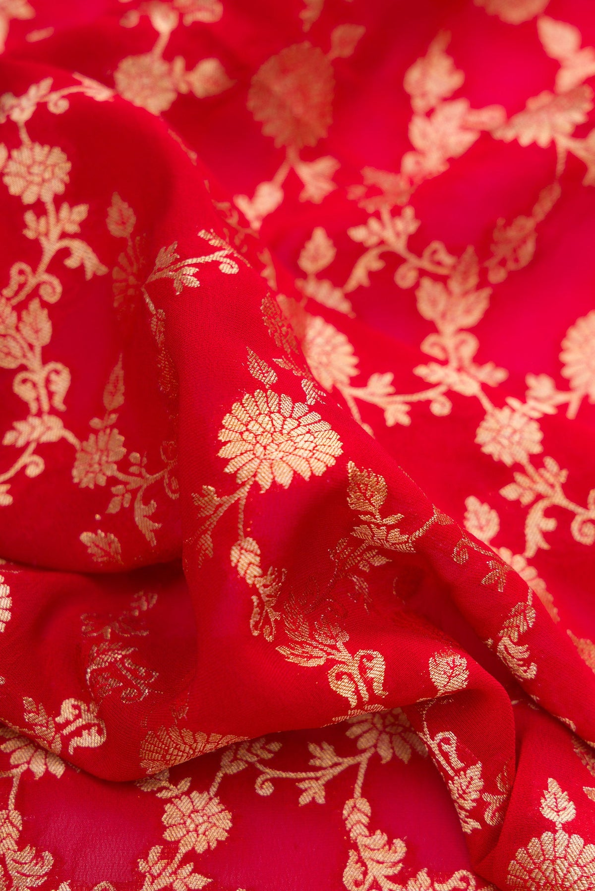 Close up of Red Dual Tone Blended Banarasi Georgette Saree with Zari Brocade on the body and Zari Border.  displaying folds