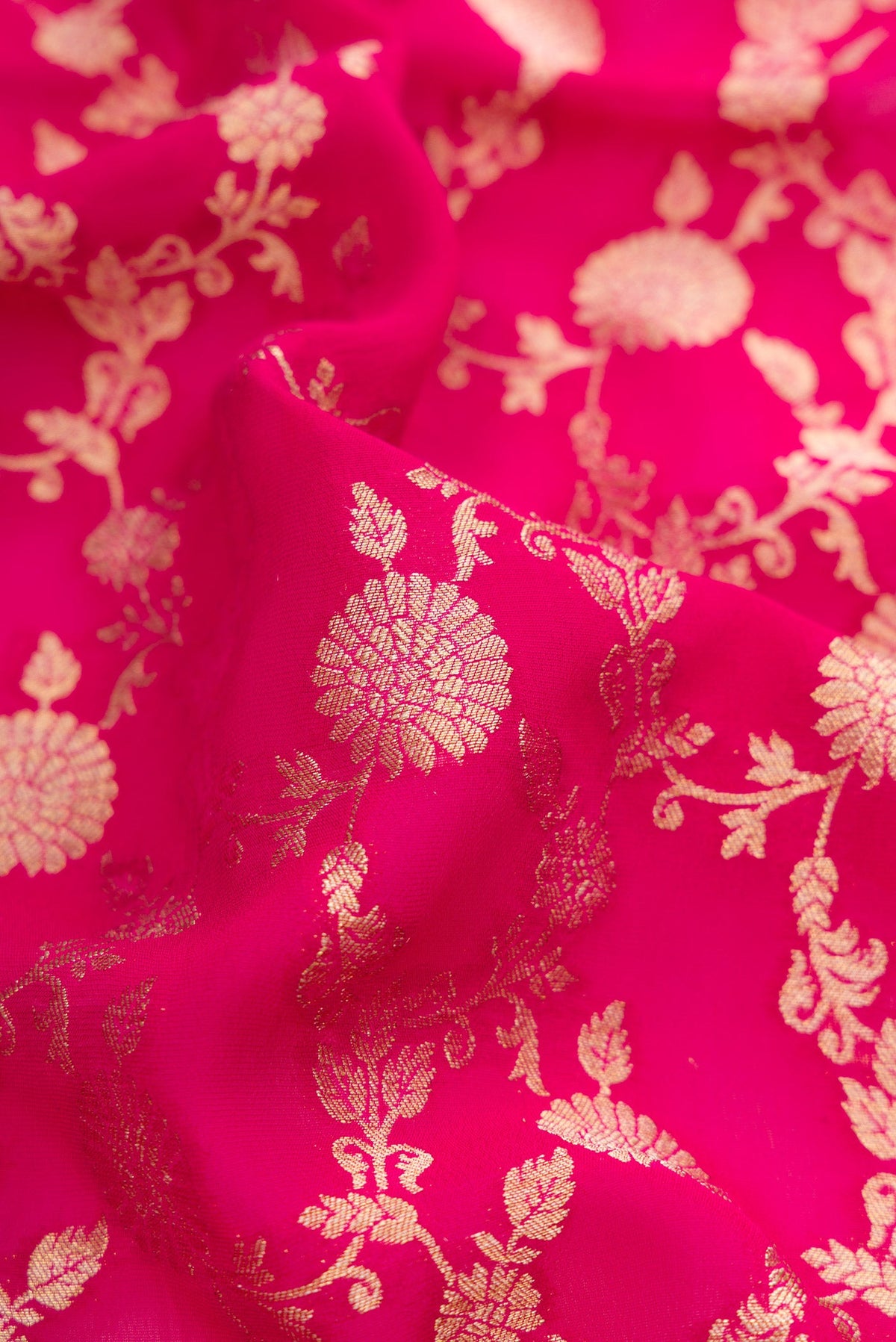 Close up of Pink Blended Banarasi Georgette Saree with Zari Brocade on the body and Zari Border.  displaying folds