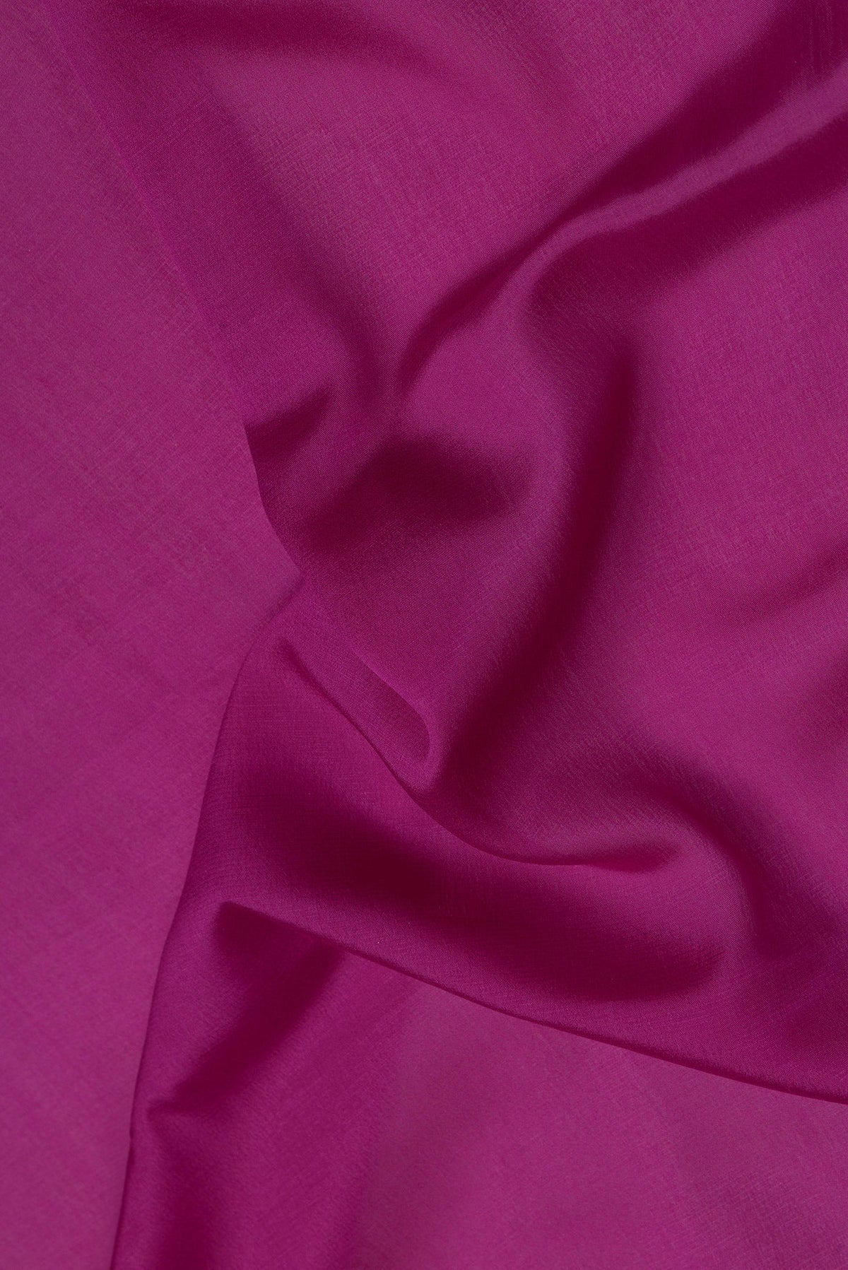 Close up of Magenta Mysore Crepe Saree with Plain Body and Zari Border.  displaying folds