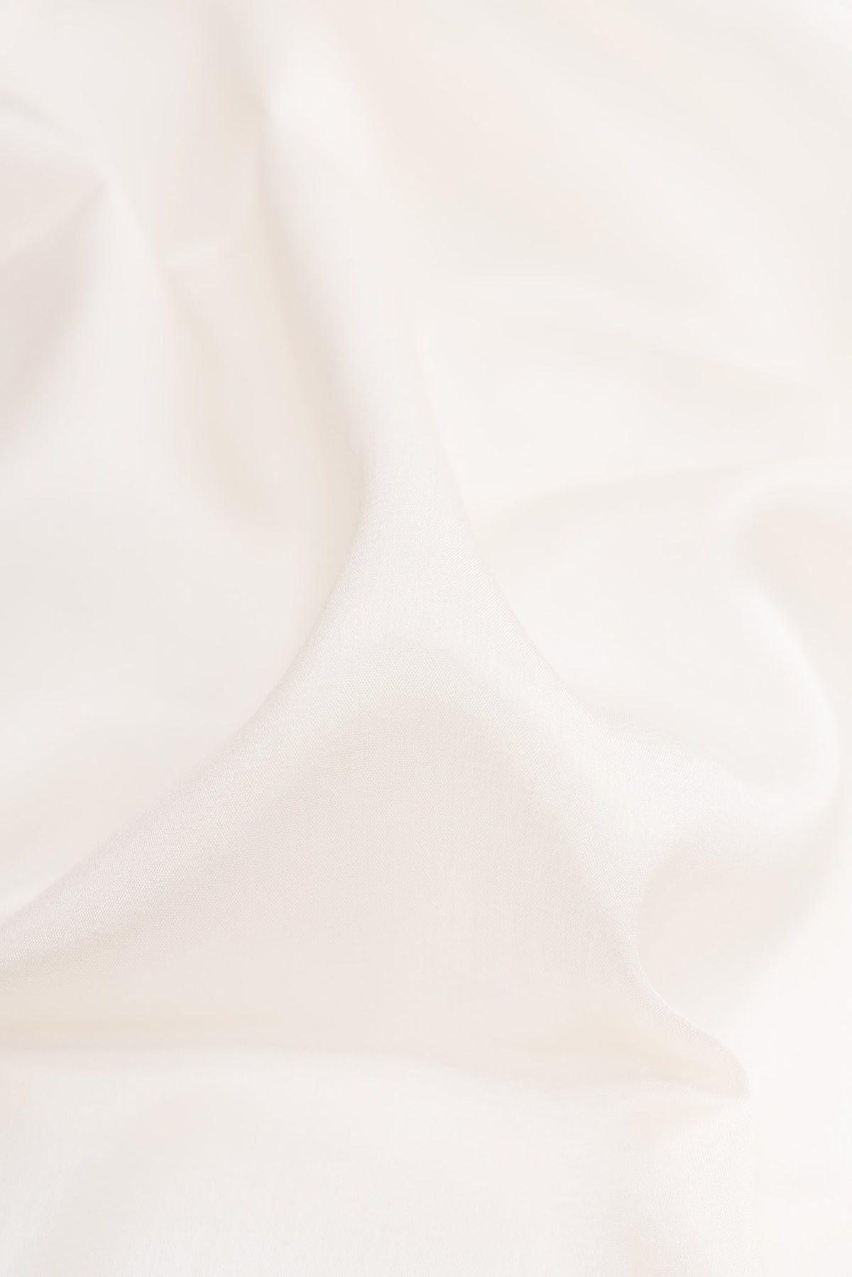 Close up of Off White Dual Tone Mysore Silk Saree with Plain Body and Zari Border.  displaying folds